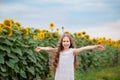 Beautiful portrait of a girl with long hair on a background of a field with sunflowers Royalty Free Stock Photo