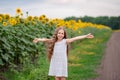 Beautiful portrait of a girl with long hair on a background of a field with sunflowers Royalty Free Stock Photo