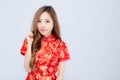 Beautiful portrait happy Chinese New Year young asian woman wear cheongsam fashion smile with gesture congratulation Royalty Free Stock Photo