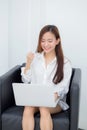 Beautiful of portrait happy young asian woman using laptop work with success on chair in the home Royalty Free Stock Photo