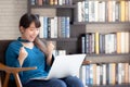 Beautiful of portrait happy young freelance asian woman using laptop work with success on chair in the home Royalty Free Stock Photo