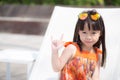 Beautiful portrait little girl asian of a smiling sitting at swimming pool Royalty Free Stock Photo