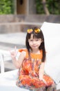 Beautiful portrait little girl asian of a smiling sitting at swimming pool. Royalty Free Stock Photo