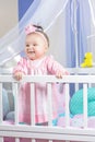 Beautiful portrait of a little girl in a pink dress in a nursery Royalty Free Stock Photo