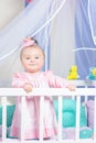 Beautiful portrait of a little girl in a pink dress in a nursery Royalty Free Stock Photo