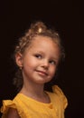 Beautiful portrait of a little smiling girl on a black background Royalty Free Stock Photo