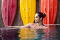 Beautiful portrait mixed race young woman in a swimming pool. Royalty Free Stock Photo
