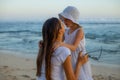 Beautiful portrait of mother hugging daughter on the beach. Family concept. Relationship between mom and daughter. Spend time Royalty Free Stock Photo