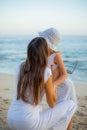 Beautiful portrait of mother hugging daughter on the beach. Family concept. Relationship between mom and daughter. Spend time Royalty Free Stock Photo