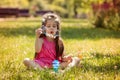 Beautiful portrait of sweet lovely little girl blowing soap bubbles