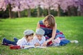 Beautiful portrait of two adorable caucasian boys and mother, re Royalty Free Stock Photo