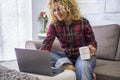 Beautiful portrait of woman work with laptop computer at home - shopping and job activity with online technology for free people Royalty Free Stock Photo