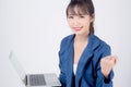 Beautiful portrait young asian business woman smiling and cheerful holding laptop computer isolated