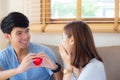 Beautiful portrait young asian couple gesture holding heart shape together, husband give heart shape wife cheerful smiling