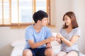 Beautiful portrait young asian couple give a cup of coffee with smiling and happy together