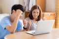 Beautiful portrait young asian couple working laptop with smile and happy sitting in bedroom, man and woman using notebook Royalty Free Stock Photo