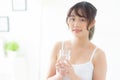 Beautiful portrait young asian woman caucasian smiling with nutrition thirsty and drinking glass of water mineral with fresh and. Royalty Free Stock Photo