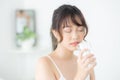 Beautiful portrait young asian woman caucasian smiling with nutrition thirsty and drinking glass of water mineral with fresh Royalty Free Stock Photo