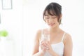 Beautiful portrait young asian woman caucasian smiling with nutrition thirsty and drinking glass of water mineral with fresh Royalty Free Stock Photo