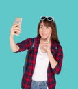 Beautiful portrait young asian woman cheerful smiling and take selfie on smart mobile phone. Royalty Free Stock Photo