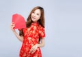 Beautiful portrait young asian woman cheongsam dress smiling holding red envelope on white background