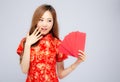 Beautiful portrait young asian woman cheongsam dress smiling holding red envelope on white background