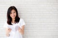 Beautiful of portrait young asian woman happiness relax standing reading book on concrete cement white background Royalty Free Stock Photo