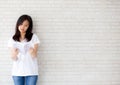 Beautiful of portrait young asian woman happiness relax standing reading book on concrete cement white background Royalty Free Stock Photo