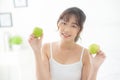 Beautiful portrait young asian woman holding and eating green apple fruit in the bedroom at home Royalty Free Stock Photo