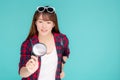 Beautiful portrait young asian woman looking something with magnify glass for planning guide to travel summer trip