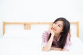 Beautiful portrait young asian woman lying and smile while wake Royalty Free Stock Photo