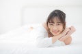 Beautiful portrait young asian woman lying and smile while wake up with sunrise at morning, girl with happy and fun Royalty Free Stock Photo