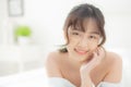 Beautiful portrait young asian woman lying and smile while wake up with sunrise at morning, beauty cute girl happy and cheerful