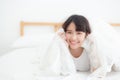 Beautiful portrait young asian woman lying and smile while wake up with sunrise at morning, girl with happy Royalty Free Stock Photo