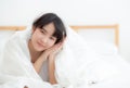 Beautiful portrait young asian woman lying and smile while wake up with sunrise at morning, beauty cute girl happy Royalty Free Stock Photo