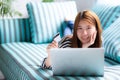 Beautiful of portrait young asian woman lying users credit card with laptop, Content girl shopping online. Royalty Free Stock Photo