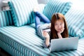 Beautiful of portrait young asian woman lying users credit card with laptop, Content girl shopping online. Royalty Free Stock Photo