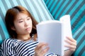 Beautiful of portrait young asian woman relax lying reading book on sofa in bedroom at home Royalty Free Stock Photo