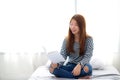 Beautiful of portrait young asian woman relax sitting reading book on bedroom at home. Royalty Free Stock Photo