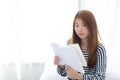 Beautiful of portrait young asian woman relax sitting reading book on bedroom at home, girl study literature, education and Royalty Free Stock Photo