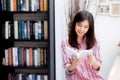 Beautiful of portrait young asian woman relax sitting reading book in living room at home, girl study literature.