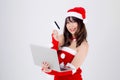 Beautiful portrait young asian woman in santa holding credit card and laptop computer for shopping online in Christmas Royalty Free Stock Photo