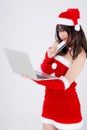 Beautiful portrait young asian woman in santa holding credit card and laptop computer for shopping online in Christmas holiday Royalty Free Stock Photo