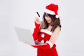 Beautiful portrait young asian woman in santa holding credit card and laptop computer for shopping online in Christmas Royalty Free Stock Photo