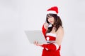 Beautiful portrait young asian woman in Santa thinking idea and holding credit card and laptop computer Royalty Free Stock Photo