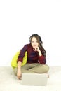 Beautiful portrait young asian woman sit on the floor with laptop and headphone on white background.