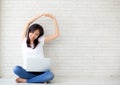 Beautiful portrait young asian woman sitting with laptop stretch Royalty Free Stock Photo