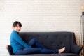 Beautiful portrait young asian woman sitting and smiling happy and looking at camera on sofa with casual at living room Royalty Free Stock Photo