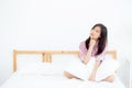 Beautiful portrait young asian woman smile confident thinking while wake up in the bedroom, girl sitting expression serious or do Royalty Free Stock Photo