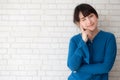 Beautiful portrait young asian woman smiling and confident thinking with cement and concrete background